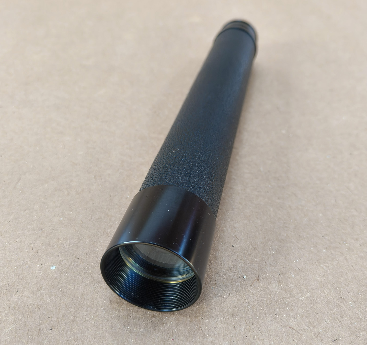 For sale is a vintage N & B Ltd London “PETREL” x30 handheld 2-draw telescope, complete with its original brown canvas and leather carry case. This is a classic British-made tubular spyglass with a 30× fixed magnification, designed for field use, birdwatching, nautical spotting, and general outdoor observation. The telescope features a black textured metal body, a smooth draw-tube extension, and quality optics typical of mid-20th-century British craftsmanship.